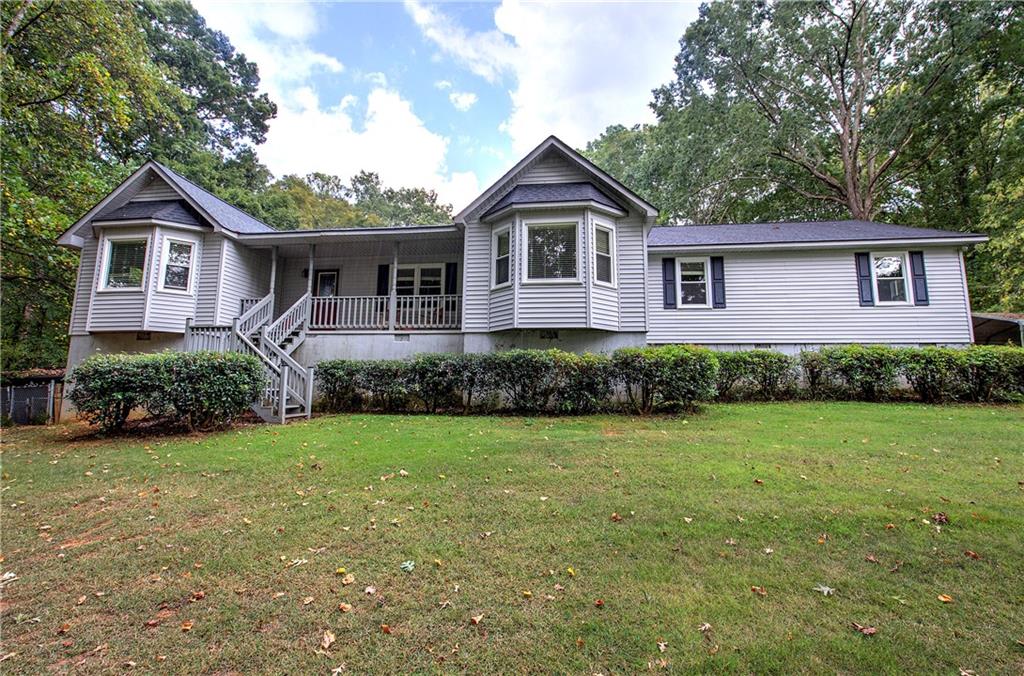 Welcome to this stunning one-level ranch-style home situated on five private acres with a long, winding driveway framed by mature hardwood trees. This spacious residence features three bedrooms and three and a half bathrooms, offering both comfort and functionality. Designed for relaxation and entertaining, the home boasts an in-ground swimming pool with a charming pool house and a second kitchen, providing convenient access for outdoor gatherings and poolside dining. In addition to the main home, the property includes a three-bedroom, two-bath mobile home with a newer roof and HVAC system, perfect for extended family, guests, or rental income. With its serene setting and abundant outdoor space, this property offers a private retreat while remaining close to everything you need. Located just minutes from interstates, highways, shopping, Hamilton Crossing Park, schools, restaurants, hospitals, and country clubs, this property combines the best of country living with modern convenience.