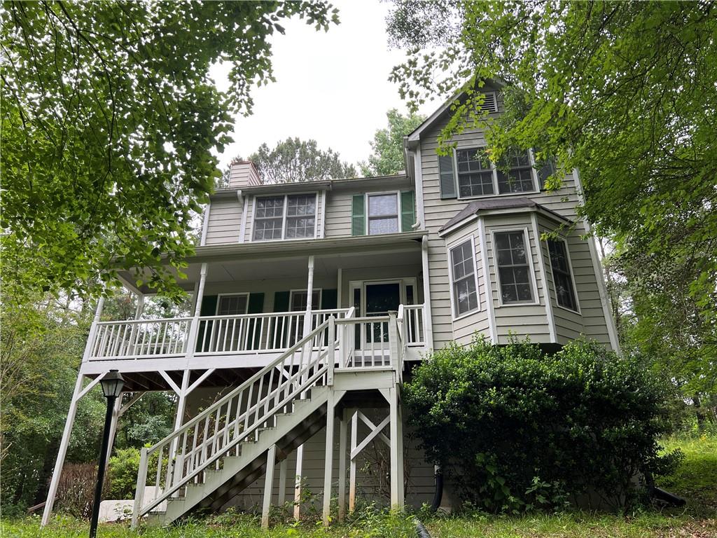 Wonderful cape cod style home in the HOA free neighborhood of Summer Glen in Dallas Georgia! This 3 bed, 2.5 bath home is looking for new owners to call home! As soon as you walk up you are greeted by a rocking chair front porch that overlooks your 1.39 acres of land. Inside a private living room and dining room greet you along with an open foyer. Fireside living room with luxury vinyl plank floors leads you right to the kitchen! Kitchen has stained cabinets, laminate counters, eat in breakfast area and a door to the oversized back deck. Primary suite on the second level has tall ceilings, laminate floors, HUGE walk in closet and private bathroom make is a must see. Upstairs includes two well sized bedrooms each with tons of natural light, closets and they share a full bath. Downstairs includes a finished room that could make for a project, storage room or workshop. Two car garage has plenty of storage. Backyard is very private and is overlooked by a massive wooden deck. Tons of curb appeal, space, natural light and this quiet neighborhood is an added bonus. Located near major highways, shopping, grocery stores and parks. Come check out this Dallas home before it's gone!