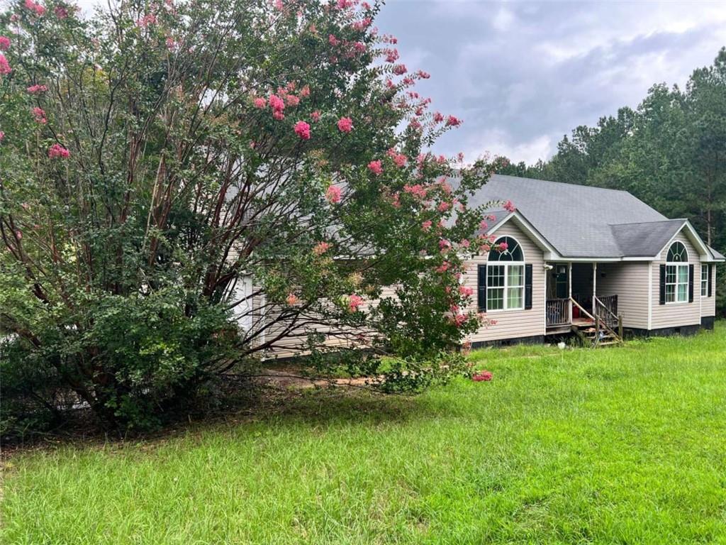 19.87 Beautiful Acres! Enjoy the extreme privacy with walking trails throughout the property! Home needs a little TLC, 4 bedrooms, 2 master suites, large fireplace in living room, 2 car garage and plenty of room to spread out.