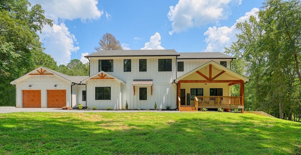 Charming Farmhouse tucked away on a level 3.34-Acre Lot in an Unbeatable location! A stunning 1-year old Farmhouse designed for living beautifully & practically. No HOA, your own private retreat w/ no visible neighbors, yet still close to everything! A welcoming front porch invites you to step inside the heart of the home-where a two story grand living room flows seamlessly into a gourmet kitchen. Black Framed windows allow an abundance of natural light into the entire home. The Kitchen features a Massive Center Island, Elegant White Quartz Countertops, White Cabinets, Seating for at least 5 at the Breakfast Bar. Stainless Appliances include a Samsung Double Oven & Gas Range (wifi-enabled) and Farmhouse Sink set into the main counter area for both style & function. A Butler's Pantry elevates the space with Extra Cabinetry topped with Butcher Blocks, Generous Shelving, an additional Sink & space for a Refrigerator. The Master Suite is located on the main floor w/ French Doors opening up to the Back Porch. The Master Bathroom offers an oversized Double Shower, His/Her sinks, and Large Walk-in Closet. The Laundry Room is located on the Main Floor with easy access through the Master Bath or Hallway near Mudroom area. There is an additional Room on the Main Floor, used as an Office or Guest Bedroom, with its own Full Bath. Upstairs, discover an Open Loft Area, 3 additional Bedrooms, and shared living area. A Teen or Nanny Suite includes its own private Full Bathroom & Walk-in closet. Two additional Bedrooms share a Full Bathroom with Double Sinks, separate Shower/Toilet room. The Unfinished Basement awaits your finishing touches, completely framed out, stubbed, and fully insulated. The Basement offers an exterior exit leading to the backyard & a garage that can be used as a workshop, storage for tractors/lawn equipment. In total, there are 4 Garage Spaces: 3 on the main level, including two front-facing, and one side-facing garage. The Backyard is just as impressive as the home, featuring a super-sized Back Porch that overlooks your future Backyard Oasis. Septic Tank is positioned on the side of property, set up to build your dream pool anywhere in the backyard. The entire home is Spray Foamed to improve energy efficiency and reduce utilites. Whether you are dreaming of wide-open spaces, a backyard oasis, an abundant garden, a sprawling yard perfect for pets, play, or outdoor adventures, this property offers acres of possibilities!