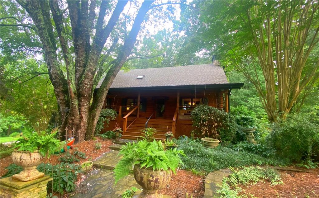 A Mystical Log-Home, Horse Property Retreat on 10.29 Acres – Minutes from Canton Marketplace & Downtown Canton. Experience the perfect blend of tranquil countryside and vibrant community at this one-of-a-kind 3-bedroom, 2-bath custom log home. Positioned just moments away from both Canton Marketplace—a major, long-standing retail pavilion with over 40 vendors—and the charming, walkable Historic Downtown Canton nestled around Main Street and Cannon Park. Property Highlights: Master suite on the main level—effortless living for everyone. Grand great room with large fireplace, rich in character, warmly bathed in natural light. Idyllic sunroom—a serene sanctuary to enjoy morning coffee or an evening view across rolling acres. Kitchen and breakfast room—perfect for relaxed gatherings and casual meals. Expansive finished basement—a large multipurpose space ideal for a media haven, gym, or hobby studio. Six-horse-stall barn, with four implement stalls, ready for your farm projects. Three lush, fenced pastures—great for turnout and grazing. A full arena—perfect for riding, training, or practicing at your every whim. This property masterfully delivers a serene, storybook-like home experience—wrapped in rustic charm—while keeping you closely connected to the exciting energy of Canton’s vibrant retail and cultural districts. Embrace the lifestyle where wide-open spaces meet city-adjacent convenience. Whether your vision includes riding in the arena at sunrise or browsing Canton Marketplace just down the road, this mystical place offers it all.