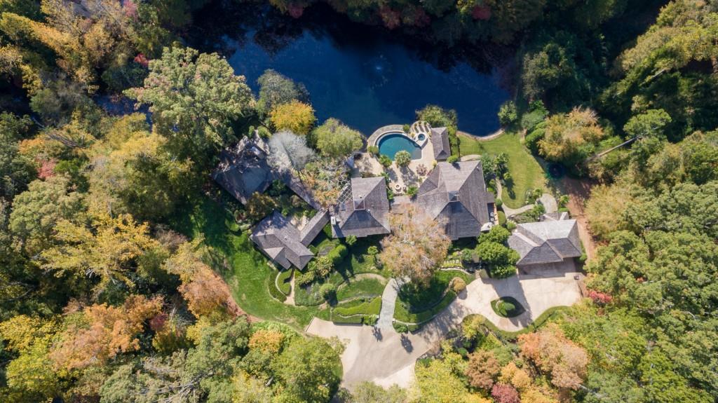 Vacation everyday in the heart of Buckhead! Spectacular lakefront gated estate nestled on 4.11 acres of private resort-style grounds. Heated saltwater infinity pool & spa, poolside cabanas & outdoor kitchen all overlooking private natural spring fed lake. Gorgeous light drenched interiors designed for entertaining. Incredible chef's kitchen w/ professional appliance package is open to the magnificent banquet-sized great room. Secluded master suite w/ fireside sitting room & spa bath. Nanny suite, full terrace level, gym & more. Guesthouse w/ 2nd kitchen & full bath.