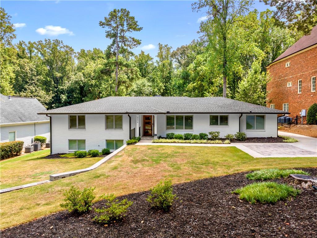Beautifully remodeled and thoughtfully designed, this spacious 5-bedroom, 3-bath brick ranch offers modern comfort, timeless style, and exceptional indoor-outdoor living in one of Smyrna’s most desirable neighborhoods. The open-concept layout is filled with natural light and features white oak hardwood floors and designer finishes throughout. The chef’s kitchen is a true centerpiece, complete with a 48” KitchenAid gas range, double convection ovens, quartz countertops, pot filler, microwave drawer, oversized farm sink, custom cabinetry, and a large walk-in pantry. The primary suite overlooks the private backyard and includes a custom walk-in closet and spa-style ensuite with rain shower, dual vanities, and updated LVP flooring. Additional main-level highlights include a dedicated home office with heated stone floors, a stylish mudroom, and two more bedrooms. The finished terrace level adds a large rec room, two additional bedrooms, a full bath, laundry room, and generous storage. Outside, enjoy a covered patio with a fireplace—perfect for entertaining or unwinding—surrounded by mature trees, lush landscaping, and a seven-zone irrigation system. Additional features include spray foam insulation, tankless water heater with recirculation, high-efficiency HVAC with advanced filtration, and Wi-Fi-enabled thermostats. Zoned for Teasley Elementary and minutes from The Battery, Vinings Jubilee, Smyrna Market Village, and major highways, this home blends comfort, style, and location into a truly special offering.