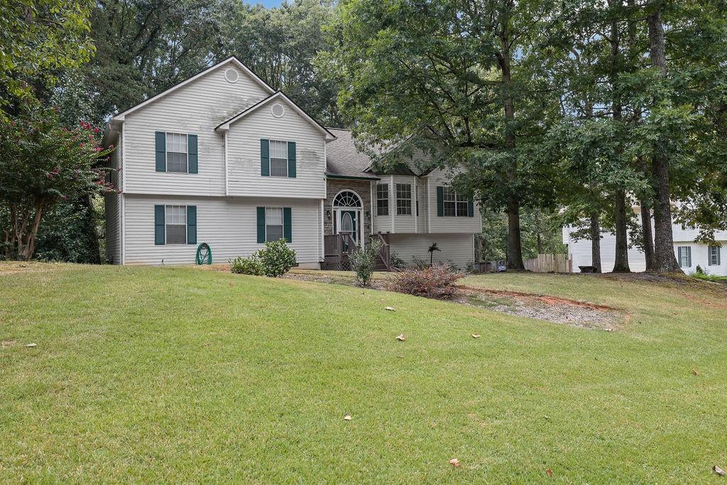 Turnkey ready and located in the highly desirable Cherokee High School District with no HOA! This beautiful home sits on a large, level lot with a private backyard that backs up to a wooded area. A long driveway and side-entry garage provide plenty of parking. Step inside to a newly renovated interior with fresh paint, soaring ceilings, and new floors throughout. The main level features a bright family room, a fully updated kitchen with white shaker cabinets, quartz countertops, newer appliances, tile backsplash, and eat-in kitchen space. A formal dining room offers the perfect setting for entertaining or can easily be converted into a home office. Upstairs you’ll find three generously sized bedrooms, including a primary suite with a fully renovated bathroom showcasing dual vanities, quartz counters, and a separate tub/shower. The secondary bath has also been updated with a modern vanity and tub/shower combo. The finished walk-out basement expands the living space with a large multipurpose room, full bathroom, and a fourth bedroom option—ideal for guests, recreation, or a home office. Priced to sell, this one won’t last long—schedule your private showing today!