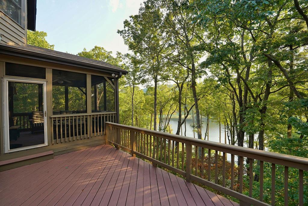 Rarely Available Lake Sconti Home!!!
Finally, a Chestnut Neighborhood mid-sized lake home for sale.
Strategically located between the Clubhouse and the Wellness Center/Mountain Beach, this 3-level home sits along Lake Sconti, providing a year-long view of the lake and seasonal mountain and golf-course views. A covered bridge is part of the view.
Currently furnished in French Château decor, the home has been carefully remodeled with beautiful tiled bathrooms and large windows. This 2383 ft.² home boasts 4 bedrooms and 3 1/2 baths, with an installed classic wooden book case/display case on the bottom floor.
The best part, however, is a top floor bump out with large windows views of the lake that can serve as a home office area.
The home layout allows for family and friends to spread out for privacy while also allowing the residents to come together for group activities.
The right buyer can walk to Big Canoe 4th of July, Christmas, and Octoberfest activities. The beach club and gym is a 1 minute drive from the home while the beautifully renovated clubhouse is just a 3 minute drive away.
The unique Chestnut neighborhood location makes the home perfect as a full-time residence, part-time vacation home, or a rental that will help the residence pay for itself.
Holiday season is upon us. The lake house has a screened in porch and deck for grilling. The main floor and bottom floor contain gas fireplaces that provide that cozy holiday home feel.
Big Canoe lakefront properties sell quickly. Don’t let this one pass you buy.