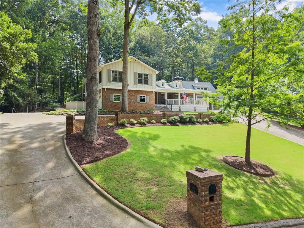 This is a super charming lake home that offers A LOT! For starters, it has been completely renovated from the studs, and redesigned with style, luxury, comfort, and function. High end selections can be found throughout, beautiful hardwoods, lovely quartz, Bosch appliances, Wolf stove, Water Works plumbing fixtures, etc. The inside space is open, cheery, and efficient, and includes 3 beds, with fabulous primary suite, wonderful chef’s kitchen, 2 living rooms, plus flex space. The 3-sides wrap around (remote controlled, retractable) screened porch is cool, cozy and inviting. Generac generator. Attached 2-car garage with charging station. PLUS, there is a second, detached, 2-car garage that also has RV parking, lots of storage and a ½ bath, with a fantastic, fully remodeled apartment above, perfect for guests (or rentable, that has separate septic and utilities.) Of course, being a lake house, there is also a private, deep-water, 32 x 28’ dock that is situated in a wonderful section of the lake, private, yet open and great for water for skiing, tubing and all the fun! The property is over 3 acres, is in highly desired N Hall school district, is close to hospital and medical corridor, and is only minutes to city services and amenities, plus shopping, entertainment and dining. Plenty of parking. Great potential for a pool. No HOA. No city taxes.