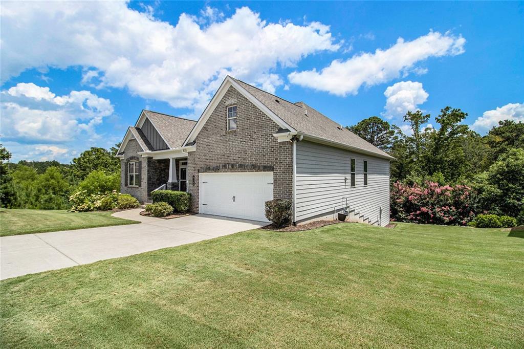 One level living on a full unfinished walk-out basement. This is a well appointed and well maintained home with many Owner upgrades. The home is sited on .41 acre lot that backs up to a wooded area to provide ample privacy. From the stacked stone accents on the front porch to the trey ceiling in the foyer, the quality and luxury you find upon entering the home continues throughout. The home features hardwood flooring in all the main areas and new carpet in the primary bedroom. The open kitchen features double ovens, a farmhouse sink, large kitchen island with pendent lighting, hidden trash receptacles, stainless steel appliances, granite countertops and recessed lighting. The separate dining room seats 12 and has plenty of room for your dinning hutch. It has huge windows with a private view and trey ceiling. All the bathrooms have tiled flooring, tiled baths and showers and and granite countertops. Besides double fans on the screened in porch and a fan in the Great Room, all bedrooms have ceiling fans. The large laundry room features a window, utility sink and cabinets. Outside you can choose to relax on the upstairs screened in porch or the open deck below accessible from the basement. Build out the space you want in the full walk-out daylight basement, stubbed for a full bathroom and still have plenty of storage left over.
Landscaping of this home is maintained by the HOA. The community also features a large pool and clubhouse and sidewalks throughout. Just minutes from shopping, dining, and local parks!