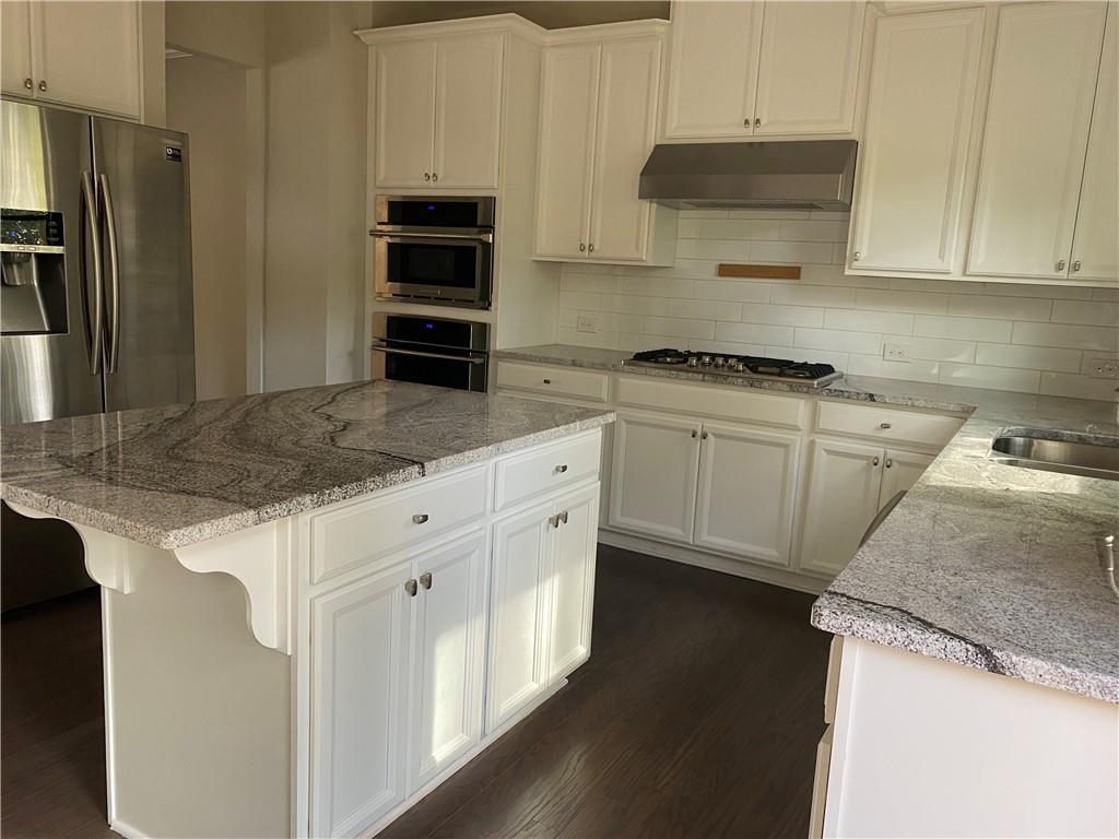 STUNNING 4 bedroom, 3.5 bathroom brick townhouse in sought-after Chamblee, just minutes from Brookhaven, Buckhead, premier restaurants, shopping, and convenient highway access. The main level impresses with soaring ceilings, gleaming hardwood floors, a stylish fireplace, granite countertops, a large island with seating, stainless steel appliances, and a dining area that flows seamlessly to a private deck off the kitchen which is great for entertaining or unwinding. Upstairs, the spacious primary suite features a generous walk-in closet and spa-inspired bath. Two additional bedrooms share a well-appointed full bathroom, with a laundry room conveniently located on the same level. The terrace level offers a versatile fourth bedroom with a full bath and direct access to the 2-car garage. Enhanced with a Ring security system and whole-home mesh connectivity, this home combines comfort, style, and modern convenience.