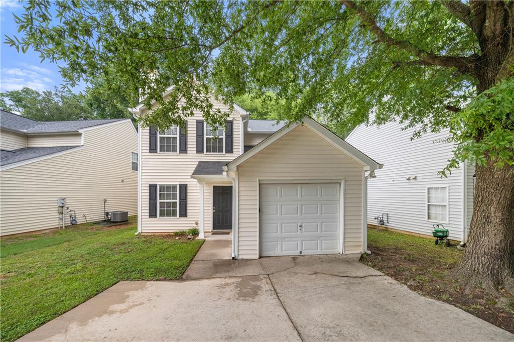 Discover this quaint home in the heart of Marietta! Move in ready and close to shopping, restaurants, trails and easy access to I-285/I-75. Through the entry, you'll find an open Living Space with fireplace, carpeted Dining Room, Kitchen and main level Primary Bedroom with ensuite bathroom. The kitchen provides stainless steal appliances, pantry and stone counter tops. The side entryway is off the dining area that leads to a freshly painted deck and open backyard. Upstairs provides three additional bedrooms as well as the second bath with a shower/tub combo, single vanity and a linen closet. This home features a one car garage where you'll find the washer and dryer. The driveway provides plenty of extra parking space. Freshly painted walls and recently cleaned carpet. Don't miss out!