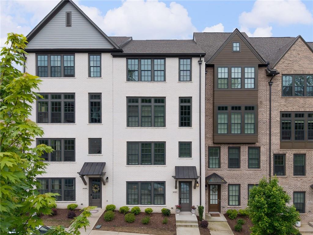 Welcome to 6807 Prelude Drive, a sophisticated sanctuary nestled in the prestigious Aria community of Sandy Springs, GA. One of the few residences equipped with a private elevator, this home is designed with premium finishes throughout, providing a touch of elegance in every room. Throughout, you will find luxurious living spaces with hardwood flooring and designer finishes like on-trend all-white paint, sleek luxury lighting and high ceilings, ensuring comfort and convenience at every turn. The open-concept main level boasts a gourmet chef’s kitchen with stainless steel appliances, farmhouse sink, and oversized quartz island. The oversized primary suite offers a serene retreat featuring tray ceilings, spa-like bath with double vanity, oversized marble shower, soaking tub, and a large walk-in custom closet, perfect for unwinding after a long day. Enjoy the convenience of nearby retail shops and restaurants in Aria Village, all within a vibrant environment that enhances your lifestyle. Positioned at the back of the community, this home ensures unparalleled privacy while still offering easy access to these vibrant amenities. For those who commute, you'll appreciate the quick access to Highway 400, making city excursions a breeze. Don’t miss this rare opportunity to own a slice of paradise in this coveted community. Come and experience the perfect blend of elegance and convenience at 6807 Prelude Drive.