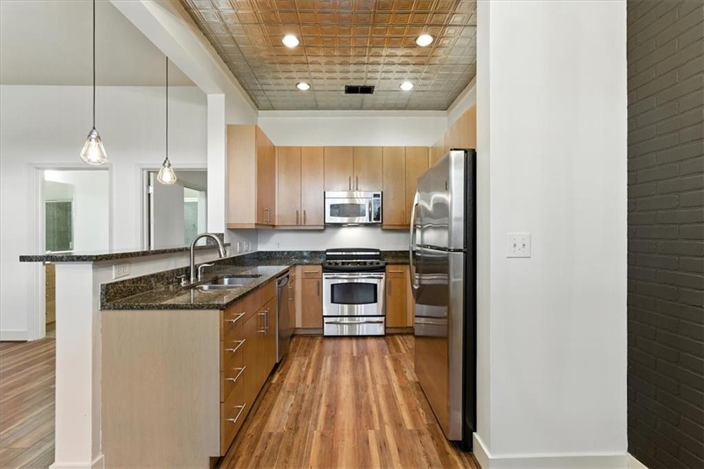 Live in the heart of it all at Duo Lofts! This freshly updated 2 bed, 2 bath condo offers the perfect blend of modern city living and industrial loft charm. Featuring fresh paint, durable LVP flooring throughout, and stylish new lighting, this move-in ready home brings together modern updates and industrial charm with its brick accent wall and open-concept layout. Enjoy a true primary suite with a walk-in closet and spacious bathroom, plus the convenience of in-unit laundry. Two private, covered parking spots are included, an in-town luxury! The community offers top-tier amenities like a private pool, well-equipped fitness center, and secure entry, all with a low monthly HOA. Unbeatable location just minutes from Mercedes-Benz Stadium, State Farm Arena, Georgia World Congress Center, CNN Center, the Georgia Dome site, and Underground Atlanta. Whether you're commuting, catching a game, or exploring the city, everything you need is right outside your door.