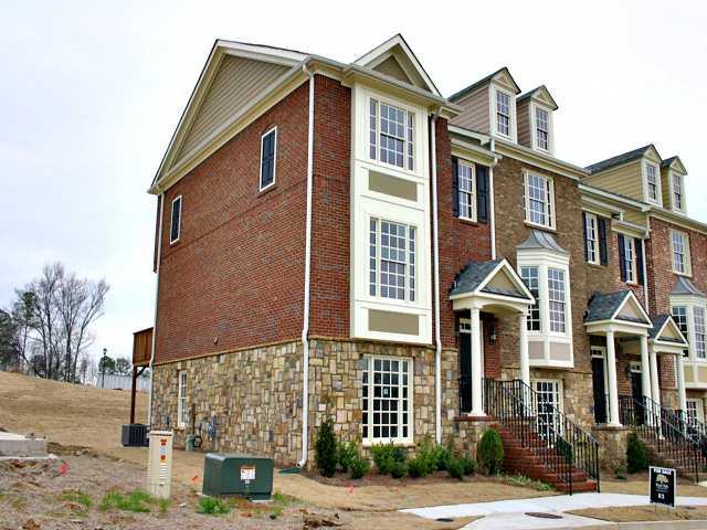End Unit! 3 bed, 3.5 bath. Bonus room with full bath. Double arches in between living room and dining room. Granite countertops in kitchen, tile in baths. Large deck, rear entrance 2 car garage. Brick and Stone front.
