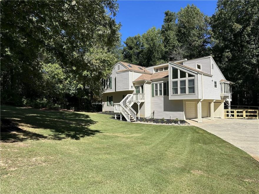 Welcome to your dream home in the sought-after Pope High School district! This stunning 4-bedroom, 3-bath residence boasts an inviting open layout with high ceilings and a cozy fireplace, perfect for gatherings. The updated chef’s kitchen features granite countertops, white cabinets, and ample space, seamlessly connecting to a separate dining area and a bright breakfast nook that opens into a spacious sunroom with picturesque views. The private, fenced backyard offers a storage area and a generous deck space, ideal for outdoor entertaining. Retreat to the expansive primary suite with abundant closet space and a fully renovated, spa-like bathroom. The upgraded guest bathroom adds a touch of modern comfort. The lower level provides a second living area with a fireplace, an additional bedroom, and easy access to a beautifully updated full bathroom. Conveniently located near freeways, shopping, and stores, this home offers the perfect blend of style, comfort, and location. Don’t miss out—this gem won’t last long!