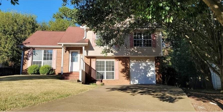 This charming 3 bedroom 2 bathroom split level home is nestled on a quiet cul-de-sac and has a fenced in backyard. Lower level has a mud room/utility room/laundry room off garage that is perfect for coming home and unloading all the stuff from your day. There is a living room with fireplace, a family room off the kitchen and separate dining area that overlooks kitchen and back patio, perfect floorplan for entertaining guests. Upstairs sits three spacious bedrooms and two full bathrooms. Conveniently located near HWY 75 access, shopping, fantastic restaurants, lake access, parks, and historic downtown Acworth!