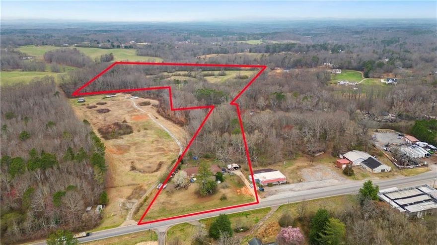 Located just 40 miles north of Atlanta. Nestled between Canton, Cumming and Alpharetta, on the main corridor of Cumming Hwy (SR20). Partially zoned GC along with the neighboring lots. Gently rolling pasture property zoned AG with conservation covenant currently in place. (Owner states pasture property is also zoned Residential and Commercial) but the county is in the process of reviewing the file to confirm.) Land acquisitions have been finalized and plans for a six-lane highway with a median and sidewalk are underway. The defined character area is suburban growth. Public water is available, sewer is less than a mile away in Forsyth County.