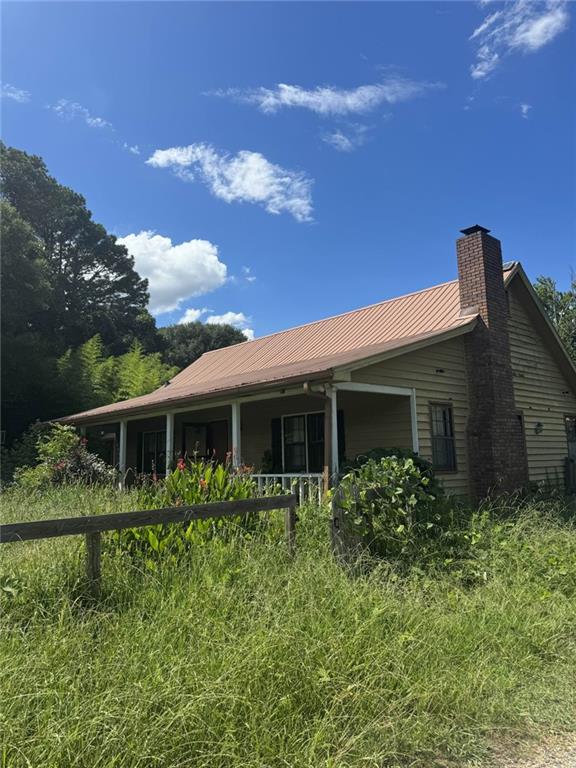Discover privacy and space with this 3-bedroom, 2-bathroom ranch-style home situated on a beautiful 4-acre lot in Cherokee County. Originally part of a land listing, this well-maintained home—built in 1979—features all main-level living with a classic ranch layout. Located in the Free Home/Cherokee school district and zoned R40, this property offers a peaceful rural feel while still being convenient to Alpharetta amenities. Enjoy open acreage, mature trees, and a serene setting—perfect for those looking for a blend of comfort and land. No subdivision or HOA restrictions.