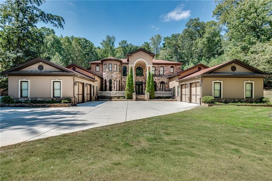Stunning estate home on an acre in a small, luxury home community that's directly across from Kennesaw Mountain! This beauty is a true bargain, given all it has to offer. Travel the tree lined driveway to the security gate, before entering the courtyard, which is flanked by two, 2 car garages and parking spaces for two additional cars. Cross over the expansive front porch and enter through the wrought iron doorway into the two story foyer with its gorgeous, crystal chandelier. The great room, with its soaring, cathedral ceiling and wall of windows opens in front of you, offering a second chandelier, a fireplace and a view of the backyard pool, spa and patio. To your left is a full bar with seating at the stone countertop, custom shelving, an icemaker and a mini refrigerator, and is adjacent to a half bath. The bar looks out to the formal dining area, which rests in an alcove of curved, floor to ceiling windows. Beyond the bar and dining area is the expansive kitchen and keeping room. The kitchen includes tons of cabinetry and granite countertops, a huge island with lots of seating and a built in cooktop. The double ovens and double microwaves are a convenient way to hold dinner parties and holiday gatherings. The walk in pantry includes plenty of built in storage. The kitchen opens to the massive keeping room, with its floor to ceiling stone fireplace, wood plank ceiling, and patio access. The breakfast nook completes this lovely, family gathering space. Exit the kitchen and walk the hall down to the roomy bedroom and ensuite bath, perfect for visting guests or family members. Beyond this large living space is an adorable "pet palace", the laundry room with storage and counter space and the first two car garage. Cross to the other wing of the main level, passing a half bath and stately office, with wall to wall wood paneling. Continue down the hallway to a bonus room, perfect for a rec space or TV room, and the master beyond. The owner's suite is a true oasis and respite from long, busy days. The fireplace and sitting room allow you to spread out and realy relax. The ensuite master bath is just incredible. There is a second, built in laundry, two water closets, separate vanities with storage, a huge, soaking tub, double shower and a to die for master closet. This wing also offers access to the second, two car garage. Make your way back to the main living area and ascend the graceful, curved staircase to the upper level. On either side of the catwalk are two sets of bedrooms and two full baths. More space and function await below the main level. The basement is massive and includes a kitchen, two and a half baths, two bedrooms and several bonus rooms that are ideal for fitness, theater or play areas. The basement also offers access to the side yard and two stairways back to the main level. The pool and spa in the backyard is a prime spot for relaxation and fun on those hot summer days. The property itself sets on a full, tree surrounded acre and has the feel of a luxurious retreat. The location is perfect, with the Kennesaw Mountain recreation area and the shopping, dining and entertainment of both Kennesaw and Marietta. You simply can't beat all of this for the price. Don't miss the opportunity to see this one!