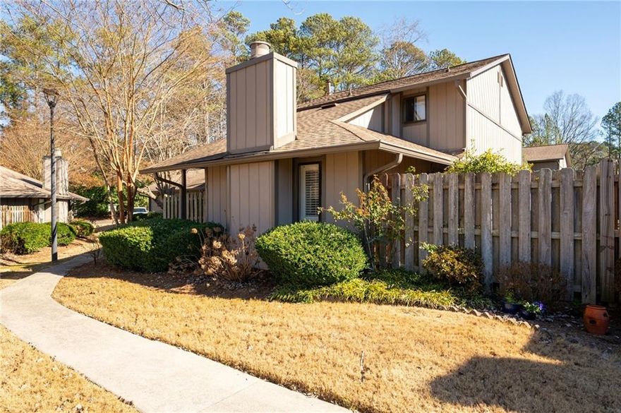 Charming 3 Bedroom, 2.5 Bath 2 story condo located in Manning Villas in Marietta.  Approx 2 miles west of the Marietta Square.  2-Car garage plus additional parking spaces for guests.  Plantation Shutters throughout! 2 fenced enclosed patios.  Updated Kitchen with extra island with lots of storage space.  Fireplace in Living room,  Dining area off kitchen, 3 Bedrooms and 2 Full baths upstairs.  Master Suite has a walk-in closet.   Half Bath downstairs.  New HVAC in 2024. This beautiful community offers a clubhouse and pool.  Great location!  Walking distance to Burrus Elementary School.