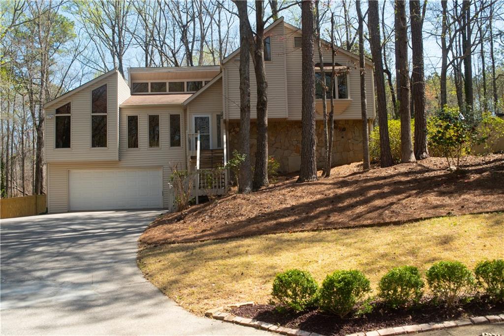 Beautifully Updated Home in the Highly Sought-After Lassiter School District. This move-in-ready home is filled with natural light and features gorgeous hardwood floors throughout the main level. A temperature-controlled solarium offers a serene view of the garden, deck, and charming gazebo, making it perfect for year-round enjoyment. The gourmet kitchen seamlessly blends style and functionality, featuring granite countertops, a gas range, a spacious breakfast bar, and custom cabinetry. The primary suite boasts a spa-like bathroom with a frameless glass shower, while three additional bedrooms provide generous space and ample storage. The daylight terrace level expands your living space with a cozy fireplace, a full bathroom, a laundry room, and a walk-out patio. This versatile area can serve as a home office, workshop. Step outside to a professionally landscaped backyard, where a flagstone path winds through multiple garden areas filled with stunning hosta and hydrangeas. The deck is designed for entertaining, complete with a gazebo for dining, grilling, or simply unwinding.
Recent updates include new lighting, carpets, interior doors, fresh paint, and a refinished deck. Conveniently located near top-rated schools, shopping, dining, and more, this home offers the perfect blend of comfort, elegance, and prime location!