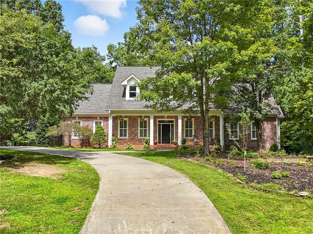 Step through the front door and you'll know-you've found the one. This expansive 6-bedroom, 4.5-bath retreat is tucked inside one of North Georgia's most sought-after gated communities, where mountain views, peaceful vibes, and timeless beauty collide. Built with enduring quality, this four-sided brick estate sits on 1.36 private acres of natural beauty. Inside, the design blends comfort and function effortlessly: Main Level Luxury: A grand primary suite with its own fireplace, a sunlit family room, and a chef's kitchen with stainless appliances, farmhouse sink, endless cabinets, and space made for gatherings. Upstairs Retreat: Two spacious bedrooms, two full baths, and a bonus room perfect for guests, kids, or your dream home office. Terrace Level Potential: Already plumbed and partially finished with a bar and half bath-just waiting to become your in-law suite, entertainment hub, or creative studio. And then there's the outdoors. ?? The current owners have poured heart and soul into lush landscaping, blooming gardens, and fruit trees now entering their second year. From the back deck, you'll hear the tranquil sound of a rushing creek on your own property-an endless soundtrack of nature. The neighborhood? Pure magic. Imagine covered bridges, hidden waterfalls, stocked ponds, and winding trails framed by wild flowers. And just outside the gates-you'll find Canoe Vineyard & Winery, your new weekend hangout spot. ?? This isn't just a house. It's a home filled with life, laughter, and love, waiting for its next chapter. For those who crave luxury, tranquility, and a story worth living-welcome home.