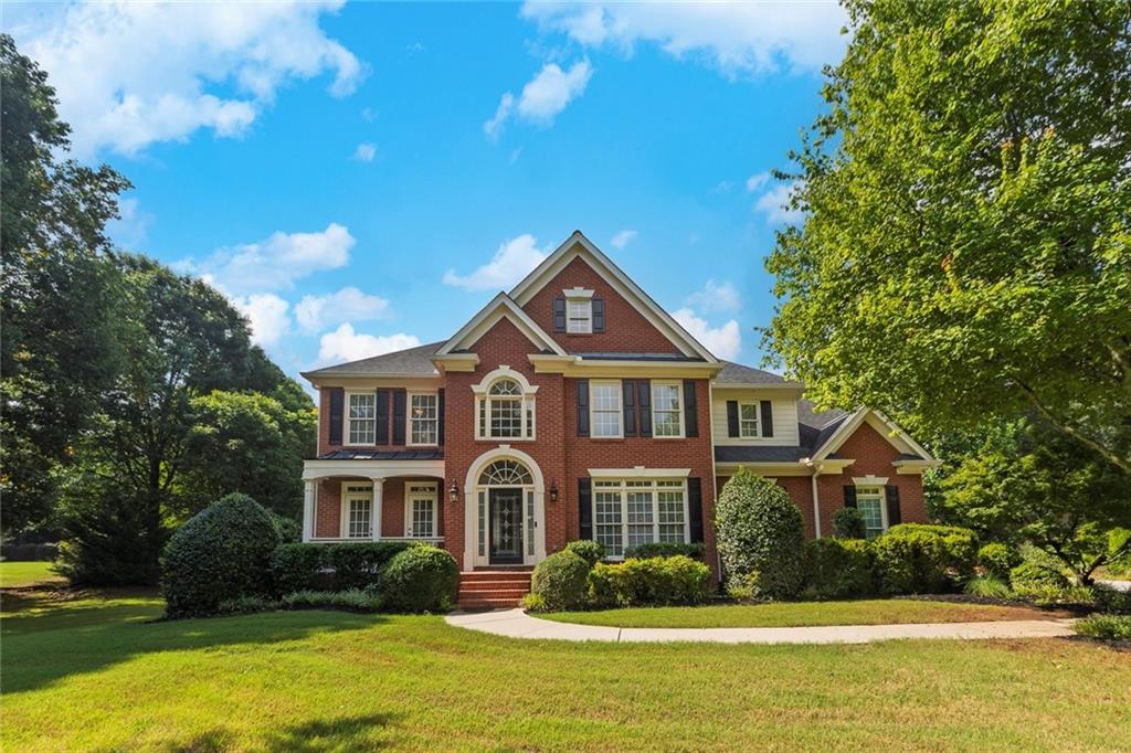 Charming and impeccably cared for traditional home located in the top rated and highly sought after Cambridge High School district in Milton! This beautifully maintained 5 bedroom, 3.5 bath home perfectly positioned on a private lot with 1 acre that offers the perfect balance of spacious living and modern elegance, all nestled in a peaceful and quiet neighborhood. As you arrive you are welcomed with lush grass, thoughtful landscape and impressive curb appeal, inviting you for awaits inside. Enter inside where you instantly feel at home with a 2 story foyer, sleek hardwood floors and the perfect amount of natural sunlight throughout. Just off the 2 story foyer includes French doors leading into the perfect home office space with views to the scenic front yard and private access to the front porch. Adjacent from office is a oversized formal dining room that is connected to the heart of the home eat in kitchen featuring, white cabinetry, wall oven and microwave, stainless steel dishwasher and fridge, spacious pantry, butlers pantry, breakfast bar and the perfect space for a coffee bar. Eat in kitchen offers easy access to a half bathroom and opens up to a lovely living room with a gas fireplace and coffered ceilings making gatherings and entertaining easy and seamless. Upstairs includes the stand out oversized primary suite with tray ceilings, a roomy seating room perfect for early mornings and relaxing evenings. Primary suite has its own spa retreat bathroom with tall vaulted ceilings, dual vanities with granite countertops and ample storage, spacious shower, free standing tub, water closet and tiled floors with an attached spacious primary closet with built in shelving. Upstairs also includes, 4 spacious bedrooms with deep closets, 2 full bathrooms with tub/shower combos and a spacious laundry room with wired shelving, storage cabinets and a utility sink. Outside, enjoy your morning coffee or evening glass of wine on the spacious patio off eat in kitchen surrounded by lush, mature landscaping. Practical meets style with the 3 car garage with built-in cabinetry adds functional storage and extra versatility. Just minutes from Avalon, Halcyon, Bell Memorial Park, Crabapple Market, North Park, Windward Parkway, and vibrant downtown Alpharetta that is filled with local coffee shops, farmers markets, evening concerts and the best eats in town, with GA 400 close by for an easy commute and endless weekend plans. This incredible home is officially seeking its new owner! Showings start Thursday, August 7th.