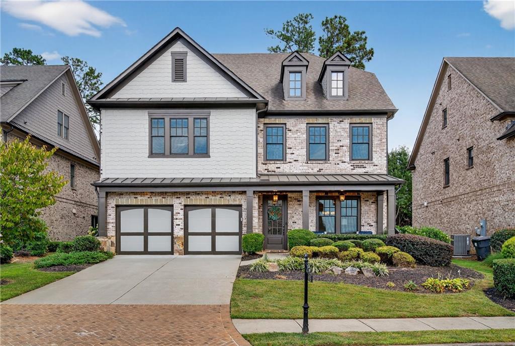 Welcome to your dream home in one of East Cobb’s most coveted neighborhoods, within the highly acclaimed Walton High School district. Just minutes from the prestigious Atlanta Country Club, home to one of Georgia’s premier golf courses, and the scenic Chattahoochee River National Recreation Area, this residence offers the perfect combination of luxury, lifestyle, and convenience. Enjoy close proximity to East Cobb Shopping Center, Whole Foods, top-rated schools, and a vibrant dining and retail scene. Nestled in a desirable swim and tennis community with clubhouse, the home invites both relaxation and recreation. A charming front porch sets the tone, ideal for enjoying morning coffee or unwinding in the peaceful surroundings. Inside, soaring ceilings, rich hardwood floors, and abundant natural light create a bright and welcoming atmosphere. The spacious living room features a cozy fireplace and custom built-ins, flowing seamlessly into the open-concept kitchen. Designed with entertaining in mind, the kitchen includes updated stainless-steel appliances, a gas cooktop, generous cabinet storage, a walk-in pantry with custom shelving, and a large island with bar seating. A butler’s pantry with floating shelving connects to the elegant dining room, perfect for hosting gatherings. The main level also includes a guest bedroom with a full bath, offering comfort and privacy for visitors. Upstairs, the expansive primary suite boasts a double tray ceiling, sitting area, oversized custom walk-in closet, and a spa-like bath. An additional guest suite with its own walk-in closet, two more bedrooms with shared full bath, and a large laundry room complete the upper level. The backyard is designed for year-round enjoyment, whether entertaining, grilling, or simply relaxing outdoors. This home is more than a residence, it’s a lifestyle. Don’t miss the opportunity to make it yours in one of Marietta’s most desirable locations.