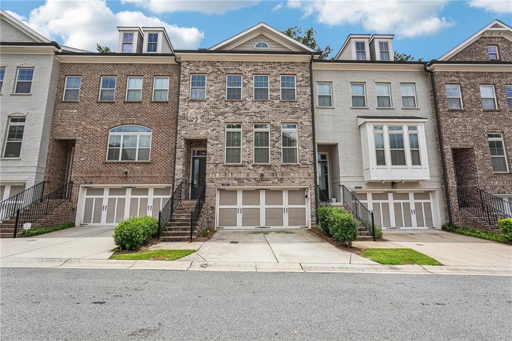 Like new, North facing townhome from The Providence Group. The largest floor plan (Foster C) with over
$20K in builder upgrades. Spacious open living with private wooded backyard! Main floor highlights
great room with gas fireplace, dining area, elegant kitchen with upgraded white cabinets, stainless steel
appliances, bespoke refrigerator, Cambria counter tops, and island offers additional seating. All
appliances convey. Upstairs 9’ ceilings, primary suite with extensive walk-in closet, Carrera marble
dual vanity, high frameless shower, garden tub. Two secondary rooms share full bath with laundry in
the hall. Terrace level offers private guest ensuite with walkout to screened porch. Hardwood floors
throughout, tiled baths, carpet in upper bedrooms only. Generous 2-car garage equipped with EV
charger. Convenient to restaurants, shopping and top-rated schools! Enjoy the maintenance free life -
HOA fee covers Exterior maintenance and roof, exterior grounds, Swim, Tennis, 2 Gates, Trash, Termite.