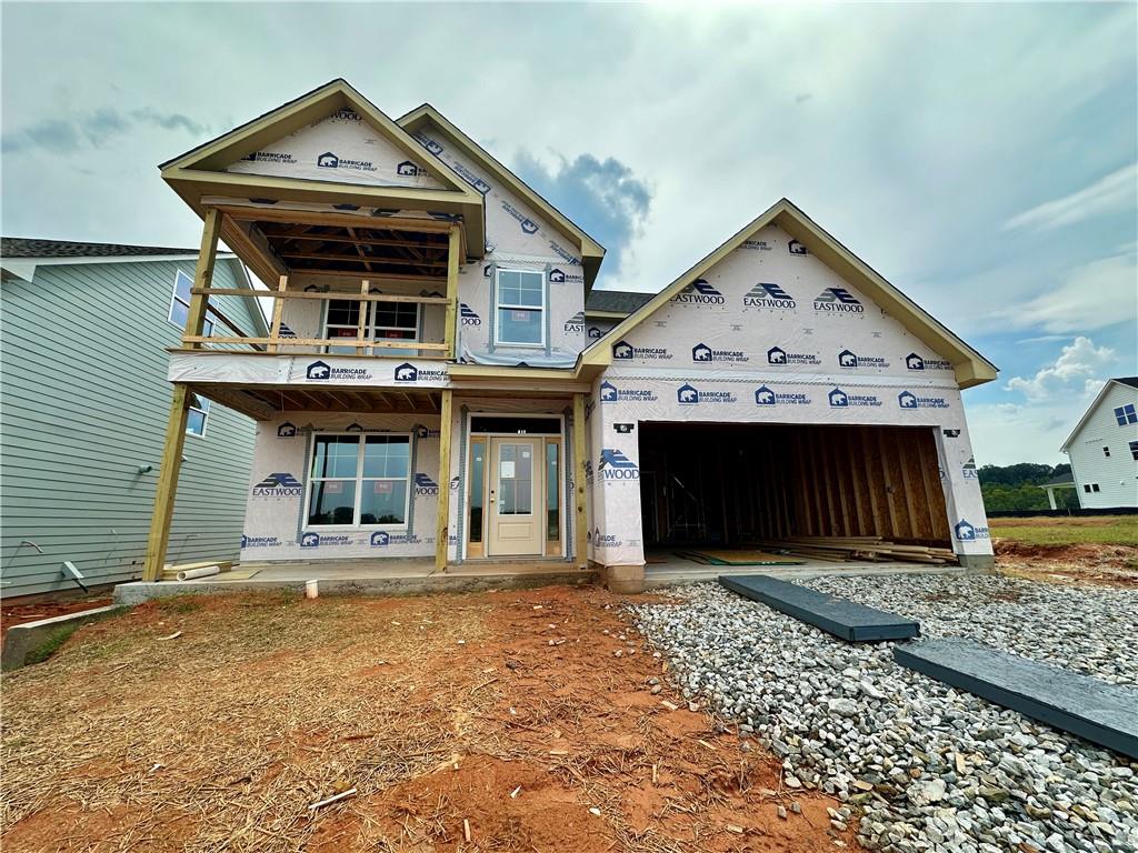 Eastwood Homes presents the Cypress plan at Twin Lakes, scheduled for completion in December. This stunning 4 bedroom, 3 bath home offers both style and function, starting with its charming double front porches, including an upstairs porch off the loft — the perfect place for morning coffee or evening sunsets. Inside, the main level is designed for modern living with a private guest suite, a dedicated office, and a screened-in back porch that extends your living space outdoors. The open-concept family room features a cozy fireplace and flows seamlessly into the kitchen, where crisp white cabinetry, a bold navy island, quartz countertops, and gold accents create a space that is as beautiful as it is functional. Upstairs, the loft makes an ideal second living area and opens directly to the upper porch for a unique outdoor retreat. The primary suite is a true getaway with spa-inspired finishes in calming gray and white tones accented by gold details, while the additional bedrooms and baths continue the home’s elevated, cohesive style. A generous backyard completes the package with room to entertain, garden, or simply unwind. Twin Lakes offers resort-style amenities with two sparkling pools, a clubhouse, fitness center, playgrounds, scenic walking trails, and, of course, two beautiful lakes at the heart of the community. Perfectly situated just minutes from I-85, you’ll have quick access to downtown Braselton and Hoschton, where some of the area’s best restaurants, shops, and breweries await. Plus, Hoschton’s calendar is full of festivals and community events, giving you even more reasons to love where you live.Special Financing: $6,000 in closing costs with the builder’s lender, Sabal Mortgage.