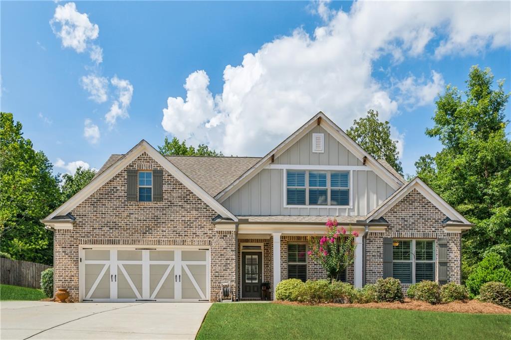 Welcome to your dream ranch-style retreat! This beautifully designed home offers a perfect blend of comfort, functionality, and style—set on nearly an acre of one of the most sought-after lots in the neighborhood. Step inside to discover an open-concept layout that's ideal for both everyday living and entertaining. The heart of the home is a spacious kitchen featuring a large island with a breakfast bar, sleek stainless steel appliances, on-trend white cabinetry, a classic subway tile backsplash, and a generous walk-in pantry. Just across the hall, you'll find a convenient mudroom with a built-in bench and extra storage—perfect for busy households. The kitchen flows seamlessly into the fireside family room, complete with custom built-in shelving and cabinetry, and a spacious dining area—making this space as functional as it is inviting. On the main level, you'll find three well-appointed bedrooms and two full baths, including a luxurious owner’s suite. Enjoy dual vanities, a soaking tub, and a separate tile shower with frameless glass surround. Upstairs, a private haven awaits with a spacious bedroom, a full bath with tile flooring, and a versatile loft area large enough for a sectional sofa—ideal for a home office, playroom, or hobby space. Additional highlights include a main-level laundry room with built-in storage and sink, brand-new LVP flooring throughout the main level living area, the foyer, hallways, kitchen, dining, and the owner’s suite. Step outside into your private backyard oasis—fully fenced and lushly landscaped, backing up to serene woods. Enjoy multiple outdoor living spaces including a covered patio, a separate grilling patio with sidewalk access to the expanded driveway, and a dedicated concrete pad perfect for a half-court basketball game, pickleball, or other activities. A storage building is also included for added convenience. This home offers a rare combination of space, style, and setting—don’t miss the opportunity to make it yours!