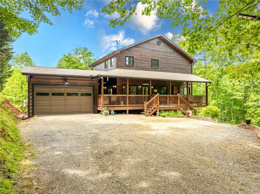 Welcome to your dream escape in the coveted Aska Adventure Area-perfectly positioned near National Forest, Toccoa River, Lake Blue Ridge & miles of hiking & biking trails. This spacious 3 BR/3BA + Loft mountain home is thoughtfully designed with a Bed & Bath on each level, offering the ideal layout for full-time living, multi-generational use, or as a vacation rental. The open-concept main level welcomes you with a seamless flow from the dining area into a well-appointed kitchen featuring abundant cabinetry, an angled island & upgraded stainless steel appliances. Soaring ceilings, walls of windows & striking floor-to-ceiling stacked stone gas fireplace anchor the inviting great room that has French doors opening to an expansive screened porch with outstanding winter mountain views & just imagine the year round views with a bit of tree trimming! The main-level oversized master is a true retreat, complete w/porch access, dual vanities, jetted tub, walk-in tiled shower & a convenient laundry closet tucked inside the ensuite. Upstairs, a spacious loft overlooks a dramatic wall of windows w/awesome mountain scenery, making it the perfect space for an office or relaxation spot. A 2nd large master suite offers a full ensuite bath + private access to a covered porch w/breathtaking mountain views perfect to enjoy your morning drink. The terrace level is made for entertaining w/soaring ceilings, game room w/pool table & bar setup & walk-out access to a covered patio & custom firepit. A 3rd large bedroom, full bath & even more storage make this level ideal for guests or family. Set on a generous 1.77AC lot, the property also has a fenced yard & gated porches for your pets + an insulated, oversized 1-car garage w/mini-split perfect for a workshop or outdoor gear storage. Tons of recent updates including newer roof, AC units, tankless water heater & more. With a versatile layout, scenic setting & upscale rustic charm, this house is your ultimate mountain home, getaway, or STR.