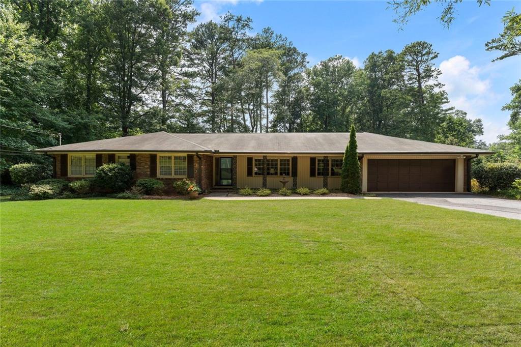 Welcome home to this beautifully remodeled brick ranch that blends timeless charm with modern luxury. Step into the renovated, designer kitchen featuring sleek quartz countertops, stainless steel appliances, and a top-of-the-line gas range—perfect for the home chef. The open-concept dining area seamlessly flows into the kitchen and spacious living room, creating an inviting space for entertaining and everyday living. Gleaming hardwood floors adorn much of the main level, while new flooring adds a fresh touch to the expansive finished basement. A cozy, separate family room and a large, enclosed porch provide even more space to relax or gather. Step outside to the updated deck, which overlooks a serene and private backyard—ideal for morning coffee or evening get-togethers.
The generously sized primary suite is designed with both style and functionality in mind, featuring two ample closets for exceptional storage. The completely renovated en-suite bath showcases a dual vanity, new flooring, and modern tile finishes, creating a sophisticated and serene space perfect for daily comfort and relaxation. The fully finished basement offers an incredible in-law suite complete with its own living room, kitchen, bedroom, full bathroom, private laundry area, and even a separate entrance with its own parking pad—perfect for guests, extended family, or rental income. You'll also find ample storage space in the large unfinished section of the basement, along with a dedicated workshop area for hobbies or DIY projects. Walking distance to Two Bridges Park, a 5-acre park featuring a splash pad, playground, and pavilions. Take advantage of the Georgetown Gateway Corridor, featuring scenic walking and biking paths that will seamlessly connect the Georgetown neighborhood to Brook Run Park, enhancing access to outdoor recreation and community amenities. Minutes away from the new High Street development with exciting dining and shopping options, Chamblee, and Brookhaven.