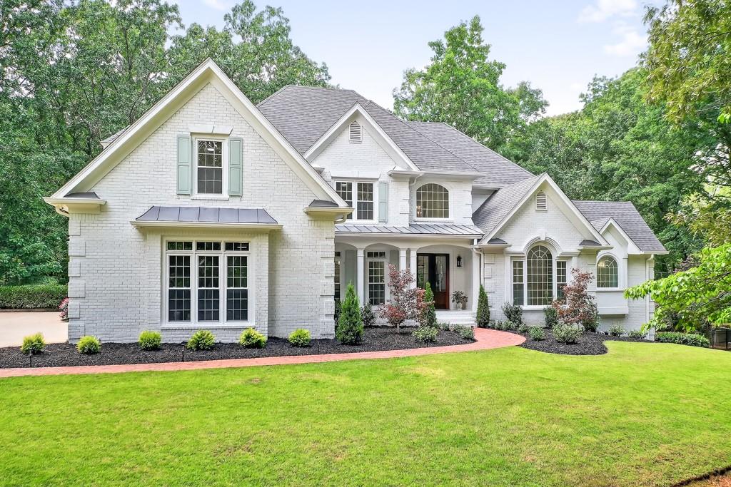 Welcome home to your dream estate! Nestled within an exclusive enclave, this fully-renovated residence sits on a sprawling 3.7-acre lot, offering the perfect balance of privacy and convenience. Located near top-rated schools—Pope, Hightower Trail, and Tritt—along with premier amenities and major thoroughfares, this home provides a peaceful retreat without compromising accessibility. Home features hardwood floors throughout its entirety, complete with upgrades galore. The main level has an entire dedicated master wing with beautiful trim, custom-built walk-in closet, dual-vanities with marble floors, make-up area, marble steam shower, separate soaking tub, private water closet, laundry room with sink - all overlooking the pool and private wooded yard. Grand two-story foyer welcomes you with an elegant dining area, massive great room with exposed beams, two-story stone stacked hearth, and views into the stunning kitchen. The kitchen features custom white cabinetry, all new stainless steel appliances with gold accents, shiplap, and matching stone on the backsplash and custom hood vent. There is high-end quartz everywhere you look, complete with a beautiful, accented kitchen island. Enjoy the abundance of natural light in the casual sitting room or the breakfast nook. Every window in the home was just replaced. Main level is complete with a moody powder room, butler's pantry, and don't miss the hidden mudroom, encased by a Murphy door. The upstairs has new banisters and balusters, 4 bedrooms, 3 bathrooms, and designer-inspired finishes in all of the newly appointed bathrooms. The terrace level features hardwoods that match the rest of the estate. Home is perfect for multi-generational living as the lower level has a bedroom and a full bathroom. You have a dedicated exercise room that could be repurposed as an office. Plenty of space for a billiards table or other activities, an abundance of storage, and last but certainly not least, a custom wet bar that envelops the exquisite home theatre. Step outside and enjoy your 30,000-gallon PebbleTec pool, complete with all-new pool decking, new tile, new coping, drainage systems, and a hot tub. The perfect place to have fun with family and friends or unwind after a long day. This is a smart home that provides control of security, climate, media, irrigation, and pool from your phone. Every inch of this home was touched, and the combination of craftsmanship and designer inspiration makes it a true stunner. Every fixture in the home is new, multiple new HVAC systems, a tankless water heater, the list goes on and on. Offering a rare blend of seclusion and convenience in one of East Cobb’s most coveted locations, this estate is just minutes from Roswell’s vibrant Canton Street and easy access to 400. This is a rare opportunity to find a home that is worthy of HGTV, combined with the coveted East Cobb location, sitting on nearly four private acres with a pool.