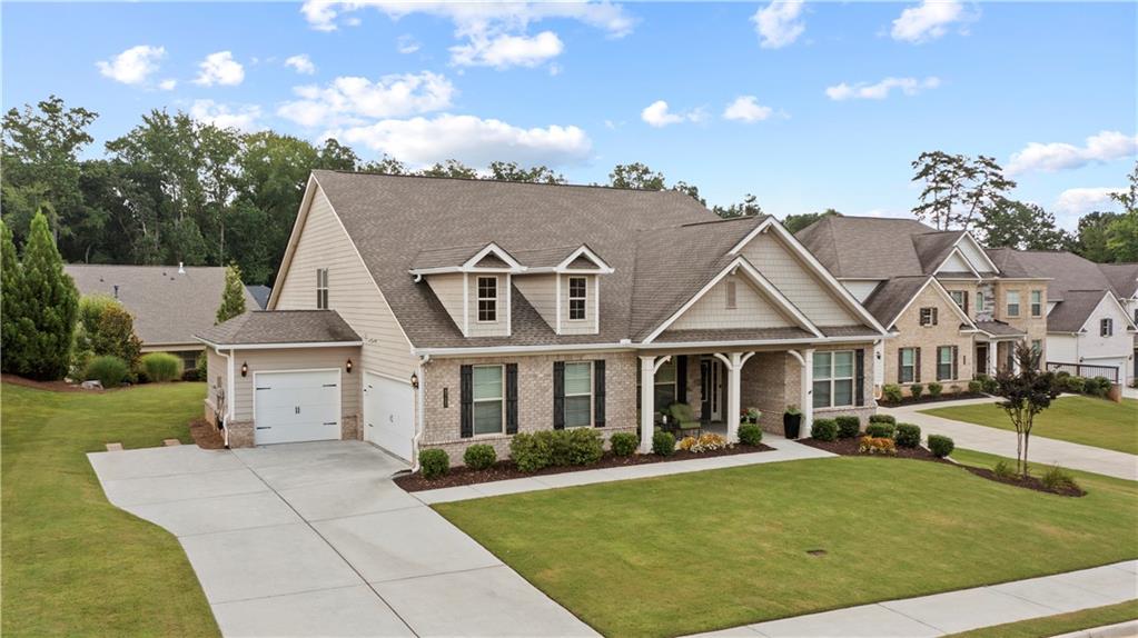 From the moment you step into the wide entry foyer, you'll feel right at home in this beautifully upgraded, 4-Bedroom Ranch feeding into sought after Forsyth County Schools. The main level boasts three spacious bedrooms, a dedicated home office, and an open concept living space that’s made for gathering. Soaring coffered ceilings, a stunning fireplace with custom wood mantle, and designer lighting create the perfect blend of comfort and style.
The heart of the home is the chef’s kitchen, featuring an oversized island with quartz countertops, double ovens, gas cooktop with designer vent hood, and a walk-in pantry to die for. The kitchen is completely open to your breakfast area, family room and dining room —perfect for entertaining or cozy nights in.
The oversized owner’s suite is your personal retreat, complete with tray ceilings, a sunlit sitting area, a spa-like ensuite with dual vanities, a walk-in shower, a soaking tub, and a fabulous custom walk-in closet.
Upstairs, you'll find a bonus family room, full bath, and 4th bedroom—a perfect setup for a teen suite, guest space, or in-law retreat.
This home is loaded with thoughtful upgrades, including designer light fixtures, crown molding, custom closets and pantry, epoxied garage floors with overhead storage, and so much more.
Step outside to your dreamy Belgard paver patio surrounded by lush, professional landscaping—ideal for relaxing or entertaining. Enjoy your morning coffee on the east-facing front porch, and wind down your evenings on the shaded west-facing back patio.
All this, just minutes from Vickery Village, Halcyon, and Fowler Park.
From front porch charm to backyard bliss, this home truly has it all—come fall in love!