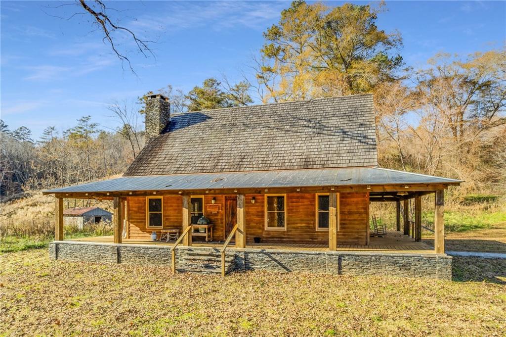 First time on the market, Sandy Bottom Farms is a 238 acre picturesque farm estate with over 100 acres of Pasture, expansive Creek Frontage, (2 Cabins). 2BR/2.5BA Cabin, plus a Meeting Cabin, a Warehouse, Beautiful Mountain Views and More. The landscape includes Bermuda hay fields, lg corn field, one of the largest water frontage stretches in the county, trout fishing, hunting, very fertile garden area. Main cabin has a southern style front porch overlooking the cow pasture, cypress and cedar siding, 100 year old heart pine floors. The meeting cabin creates the perfect place for gatherings; wood burning stove & fireplace. Cabin overlooks the creek & there's a commercial grade playground & stone picnic tables. This estate is the perfect investment for a family farm, retreat center, wedding venue, there are so many options; plus it's a fully functioning commercial farm. Appointment Required.