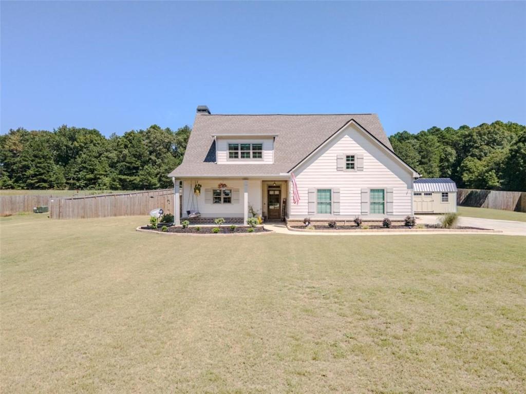 Welcome to this nearly new home in the heart of Monroe, offering a perfect balance of comfort and style. From the moment you arrive, the curb appeal shines with a welcoming covered front porch and a spacious yard ideal for outdoor enjoyment. Step inside to find an open floor plan designed for both everyday living and entertaining. The kitchen is a showstopper with its custom backsplash, sleek cabinetry, and generous island seating that flows seamlessly into the dining and living areas. The main-level owner’s suite provides a private retreat with a spa-inspired bathroom featuring dual vanities, a walk-in shower, and elevated finishes. Secondary bedrooms are oversized, with one offering its own private large bathroom, creating flexibility for guests or multi-generational living. The upstairs media and bonus space adds even more room to spread out, whether for movie nights or hobbies. Outdoors, the brand-new 16x36 resort-style pool is the highlight of the property. With an 8-foot deep end, tanning ledge with bubblers, LED lighting, and custom concrete surround, it’s designed for both relaxation and recreation. The expansive 2-acre lot provides plenty of room for play, gardening, or simply enjoying the peaceful backdrop. All of this is just a quick golf cart ride to historic downtown Monroe, with its vibrant shops, dining, and community events. This home blends quality upgrades, outdoor living, and a prime location—an incredible opportunity you won’t want to miss.