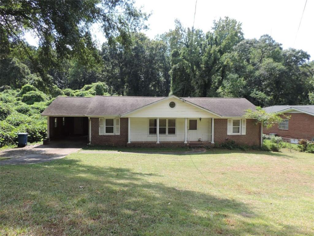 Charming 4-Sided Brick Home with Tons of Potential in East Point Sitting on a .3-acre lot, this 2-bedroom, 1.5-bath brick home offers 1,305 square feet of space and plenty of opportunity to make it your own. The solid 4-sided brick construction gives it lasting curb appeal, while hardwood floors are already exposed in the bedrooms-and believed to be under the carpet in the living and dining areas-just waiting to shine again. Whether you're looking for a starter home to update or a project with great investment potential, this property is a fantastic find. With a classic layout, generous room sizes, and easy access to downtown Atlanta, the airport, parks, shopping, and dining, it blends convenience with character. Bring your vision and creativity to unlock the charm of this East Point gem! NO BLIND OFFERS!!