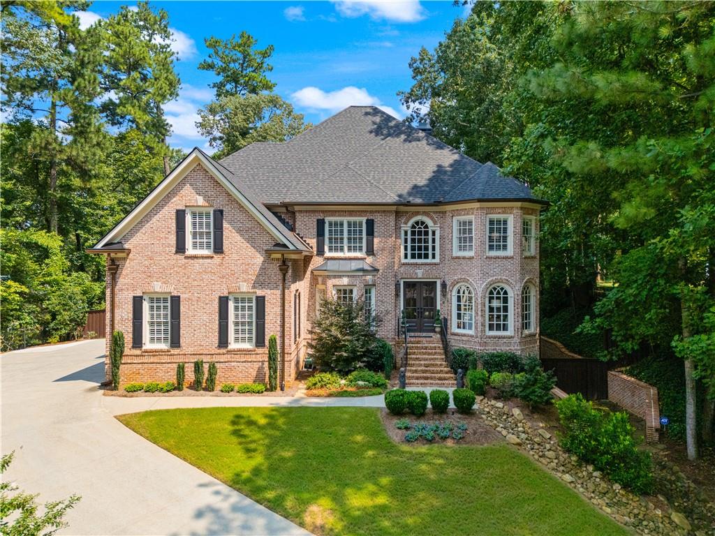 Experience timeless sophistication! A magnificent John Willis built residence that blends classic charm with modern luxury. Located in the prestigious Payton Oaks community, this residence showcases stately architecture, curated designer finishes, and exceptional livability on nearly a half-acre of private property.*** The approach is framed by professional landscaping and rustic copper-tone metal gutters. Step through the custom-made Maxcraft double front doors with Flemish privacy glass and gas lanterns, into a dramatic two-story entry foyer. Soaring ceilings with a decorative inset and a beautiful Hinkley Lighting chandelier create a grand first impression. The staircase, with wrought iron pickets, leads to a second-floor balcony overlooking the foyer.*** Open and bright floorplan is enhanced by 9-foot ceilings and beautiful custom molding, including 8-inch custom base molding and large crown molding throughout the main level. The spacious dining room, perfect for hosting, features a bay window, ceiling inset, and a crystal chandelier, with a convenient butler's pantry leading to the kitchen.*** This kitchen, recently crafted by renowned designer Cristi Holcombe Interiors, is a true work of art. It boasts stunning Calacatta Alabaster Quartz stone countertops, custom-built Costili cabinetry with soft-close maple drawers, and exquisite Italian tile flooring. The heart of the kitchen is the legendary La Cornue CornuFe 90 Albertine range, complemented by a custom-built range hood with artistic detailing by local artist Kass Wilson. This culinary haven is also equipped with top-of-the-line appliances including a Thermador refrigerator, a JennAir dishwasher and trash compactor. For ultimate convenience, there's a Fisher Paykel single DishDrawer and a KitchenAid under-counter microwave drawer. The kitchen flows into a breakfast room with a wall of windows and access to the deck, and a family room featuring a coffered ceiling, a fireplace with a composite stone surround, and built-in bookcases.*** Upstairs, the owner's suite is a private sanctuary. A barrel-vaulted ceiling with a crystal chandelier and a cozy sitting area with a gas fireplace provide a luxurious retreat. Spa-like en suite bathroom features Italian ceramic tile floors, a soaking tub, a spacious walk-in shower with glass doors, and his-and-her vanities separated by a storage cabinet. An elegant Schonbek chandelier adds a touch of sophistication to this space. The expansive walk-in closet, with a California Closet-style system, offers ample storage. Three additional bedrooms with volume ceilings and two baths offer generous accommodations, while an oversized sophisticated office with a curved wall of windows creates a stunning flexible space. A second-floor laundry room with built-in cabinets and a utility sink offer the ultimate convenience.*** The terrace level offers incredible versatility, functioning as an in-law suite with both interior and exterior access. It includes a game room, a media room that can be used as a bedroom, a full bath, a kitchenette, a second laundry room, and an exercise room. The three-car garage features new insulated doors with myQ cameras and an electric car charging port. Outside, the backyard is an entertainer's dream with a spacious wood deck, a gazebo, and low-maintenance synthetic grass.***With three HVAC systems, a new roof and gutters installed in 2024, water heaters approximately three years old, and brand-new chimney caps and pans added this year, this home has been thoughtfully updated to offer comfort, reliability, and peace of mind for years to come.***Residents enjoy recorded architectural covenants, mature oak trees cared for by an arborist, and proximity to top-rated Lakeside High School. Ideally located near I-285, I-85, Emory, CDC, CHOA, Mercer, VA, and many other private schools and school choice options. This exceptional property blends elegance, function and location. Schedule your private showing today!