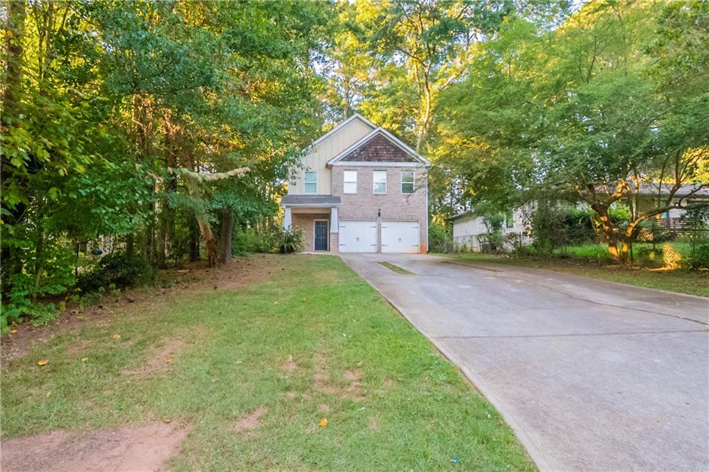 Inviting two-story traditional home in Decatur’s Hillsides neighborhood. This residence features hardwood floors throughout the main level, a comfortable family room with fireplace, and a kitchen with breakfast bar overlooking the living area. The primary suite offers a walk-in closet and bath with dual sinks, soaking tub, and separate shower. Upstairs, additional bedrooms provide plenty of space for family or guests, while the level lot offers a spacious yard for outdoor enjoyment. With its convenient location near Candler Road, shopping, dining, and quick access to I-20, this home blends everyday comfort with easy accessibility.