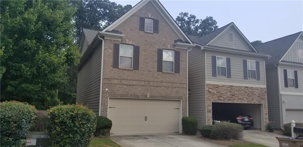 Beautiful 3 Bed, 2.5 Bath town house, former model home, granite counter top, hardwood floor on main floor, master suite features, walk in closets, close Lake Lanier Beach and Market Place Blvd, End unit.