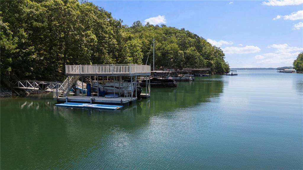 You want deep water? This lot doesn’t whisper about it—it delivers. Nearly 1.5 acres in the coveted Deer Creek Shores community hugged by 555 feet of U.S. Corps land. You’re tucked into a WIDE cove that shoots straight to the main channel—privacy with a VIP lane to the good stuff. The water is more than 25 FEET under the 24x30 aluminum dock (yes, I measured it; no guesswork), and it’s fully accessorized with a boat lift and sun deck. There are long-range lake views from the dock. No HOA, meaning no one’s going to audition for “Lake Rules Police” on your watch. If you’ve been scrolling listings like they’re trying to sell you a “cozy” puddle—stop. This is a REAL & RARE deep-water opportunity. Build the thing that makes your friends jealous. If you need builder referrals, I've got them! Survey, Soil Test & Dock paperwork available.
