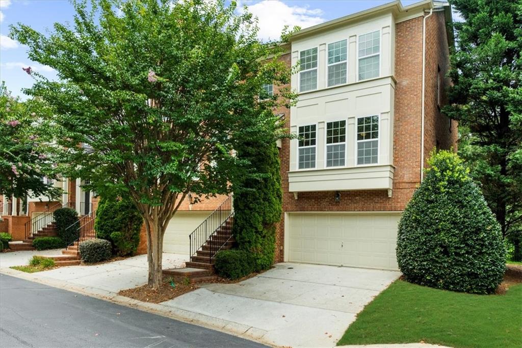 BEST LOCATION IN SMYRNA right on the East-West connector without the noise! Lots of natural light throughout home. This stunning END UNIT is conveniently located close to Truist Park, The Battery, Cumberland Mall, Cobb Galleria, Costco, Starbucks and so much more. Easy access to I-285, I-75 & I-20. Enjoy direct access to the Silver Comet Trail right at the front of the neighborhood, perfect for walking, biking, and outdoor adventures. Spacious, open layout that's great for entertaining indoors and AMAZING VIEWS from the private back deck overlooking greenary. Home is across from the pool, mailboxes and guest parking making it THE BEST location in the community. You cannot beat this location!! Water heater 2024, new carpet, new hardwoods on main level and beautiful hardwood stairs.