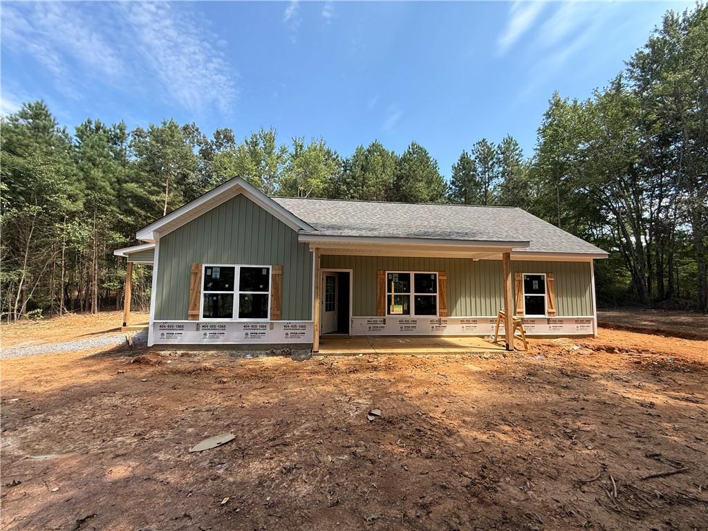 NEW CONSTRUCTION RANCH ON 3 QUIET ACRES – NO SUBDIVISION OR HOA!!! Act now for a FREE appraisal and $3,000 in incentives with our preferred lender. Conditions apply. See listing agent for details.
This stepless ranch home is under construction on a serene 3.098-acre lot -- offering the perfect blend of privacy and convenience. Conveniently located north of Buchanan off of Hwy 27 going towards Cedartown. Featuring 3 bedrooms and 2 full bathrooms, the home showcases an open layout with vaulted ceilings in the main living and dining areas for a spacious, airy feel.
There's still time for buyers to add their own personal touches! Contact the listing agent today! The kitchen is designed with granite countertops, a counter-height bar, and a stainless steel appliance package including an electric range, built-in microwave, and dishwasher. The split-bedroom layout provides privacy, and the primary suite features a walk-in closet and a bathroom with double vanities, framed mirrors, granite countertops, and a stand-up shower.
The two secondary bedrooms are generously sized and share a full bathroom with a granite vanity and a tub/shower combo. Ceiling fans are included in the living room and primary bedroom. Outside, the home will be finished in low-maintenance vinyl siding with a stone water table for added curb appeal.
This floor plan includes an attached carport.
Don’t miss this opportunity to customize your dream home in a peaceful country setting! ***Photos are of a home similar to the one being constructed, not of the actual subject property.***Construction is underway!***
