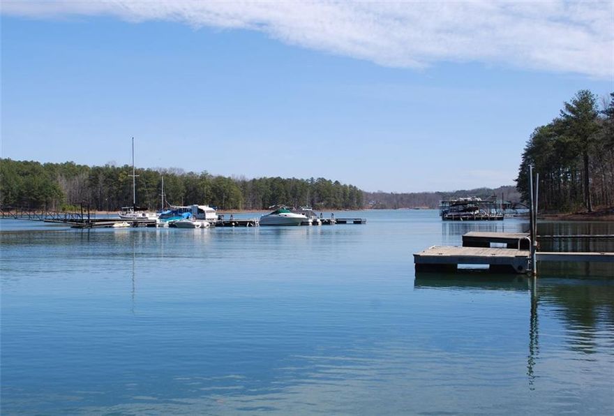 Stunning 2- stories lakefront condo with 2 bedrooms, 2.5 baths, 1392 SQ on Lake Lanier with FP, screened porch and wooded lake view.  Master on main, walk-in closet, hardwood floors, Kitchen with breakfast bar, SS appliance and pantry closed.  Community has swimming pool, tennis courts, basketball court, 3 community docks, boat parking/ storage and walking distance to boat ramp and Lanier Beach Park.  Convenient to GA 400 and Shooing.