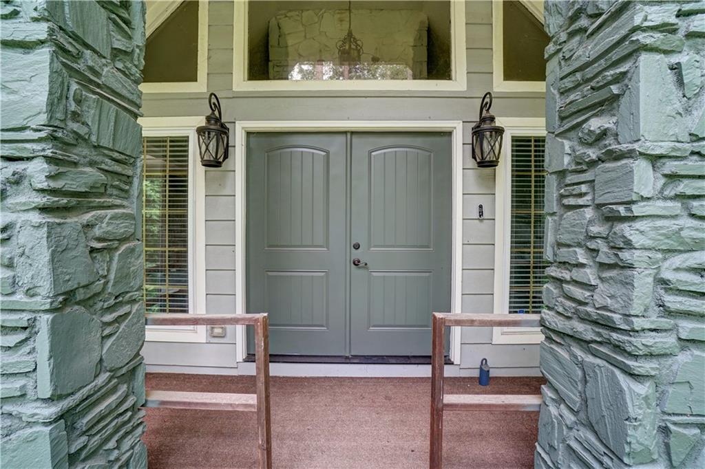 This generous, private estate nestled on nearly 2 lush acres in the serene Oakdale Estates of Douglasville, GA. This 4-bedroom, 3-bathroom home (plus bonus spaces) offers over 3,500 square feet of finished living space including a professionally finished basement, making it ideal for families seeking space, versatility, and comfort in a peaceful, low-density setting.
Spacious Living Area with vaulted ceilings, a cozy brick fireplace, and ample natural light. Formal Dining Room and eat-in kitchen with solid wood cabinetry and updated appliances. Three bedrooms on the main including a well-appointed primary suite with private bath and dual closets. Hardwood floors and plush carpet throughout the main living spaces.
The fully finished basement adds significant value and flexibility. Private Guest Suite with bedroom and full bath — ideal for in-laws or guests. Large Entertainment/Media Room with built-in shelving and direct walk-out access to the backyard. Home Office or Gym Room with closet and vinyl plank flooring. Workshop or Hobby Space, perfect for DIY projects or storage.Laundry area with upgraded appliances and additional storage closets. Expansive 1.96-acre wooded lot offering privacy, shade, and space for gardening, play, or a future pool. Two-car attached garage with long driveway for additional parking. Rear deck overlooking the peaceful backyard — perfect for entertaining or enjoying Georgia sunsets.