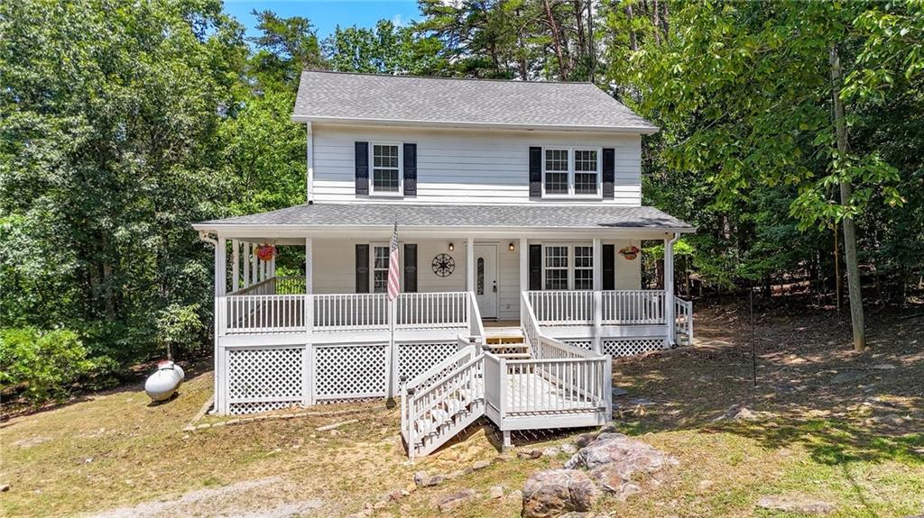 Fall in love with the classic farmhouse feel of this quaint 3-bedroom, 2.5-bath home nestled on a peaceful 1.89 acre lot. From the moment you step onto the inviting wrap-around porch, you’ll be drawn into the warmth and charm of country living. All three bedrooms and two full bathrooms are conveniently located upstairs, while the main floor offers a welcoming layout with a half bath and a spacious laundry room. The kitchen boasts white cabinetry, stainless steel appliances, and tile backsplash. Enjoy a private, wooded backyard perfect for relaxing. The septic tank has just been pumped, and the windows were replaced five years ago, offering added peace of mind. Located in a quiet community with lake access through the HOA, this home offers the perfect mix of tranquility and recreation. Don’t miss this cozy gem—ideal for those seeking a peaceful lifestyle with modern comforts and timeless country charm.