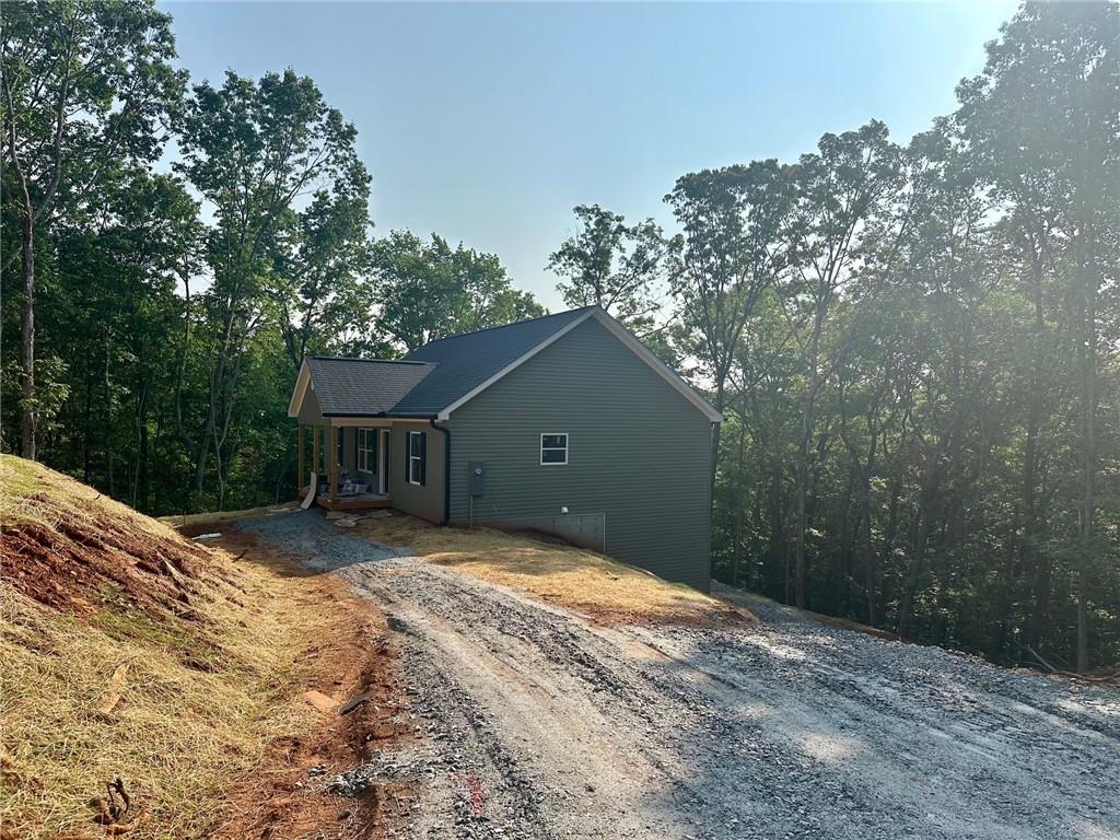 Last unit left in the highly sought after Tower Drive community off Auraria Rd in Dawsonville/Lumpkin County. This new construction 4 master suite plan will be ready for FALL! Move in August 1st, $2800 per moth or $700 per bedroom. 10 mins to UNG or Dahlonega! Safe area, easy access to Dawsonville & 400. Spacious upgraded plan. 2 oversized en-suites upstairs, and 2 downstairs. 2 living spaces, covered front & rear porches! Granite, Lifeproof flooring, vaulted ceilings, full laundry room, unfinished storage, county water, and in a community of similar styled new unites. Lawn upkeep is included. These don't ever last long, this one just happened to come back available. Call today! We have more completed units available to tour.