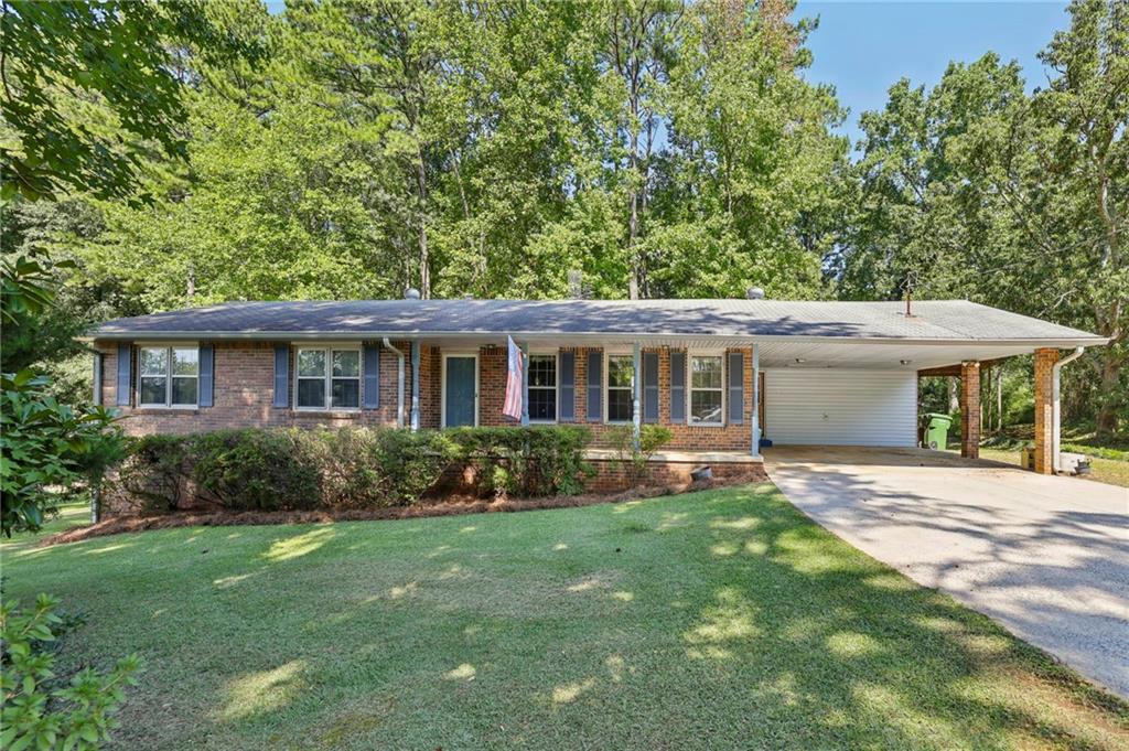 Classic brick ranch nestled on a peaceful, tree-lined street. This 3-bed, 2-bath ranch offers lots of potential! Set on an expansive lot (just under 1 acre) with mature landscaping and a private, wooded backyard, this home is perfect for anyone looking to create their dream space. Inside, you’ll find original features throughout, offering a blank canvas to make it your own. With a spacious living area, a traditional floor plan, and an inviting front porch, this home blends classic character with the opportunity for modern updates. There is a partially finished, full basement providing endless possibilities for renovation or personalization. Outside, enjoy the serene setting, complete with a long driveway and ample yard space for gardening, entertaining, or simply relaxing under the shade of beautiful trees. Convenient location close to shopping, dining, great schools, I-75, and The Battery/Truist Park. Don’t miss this chance to own a classic ranch with incredible potential.