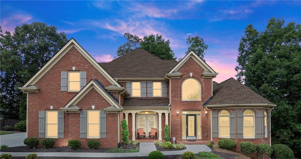 Welcome to this stunning seven-bedroom, four and a half bath three-sided brick home. Nestled in Forsyth County on the highly sought-after border between Johns Creek, Suwanee, and Duluth in the vibrant Saint Marks community, within the nationally recognized and award-winning Lambert High School district. Designed with both elegance and comfort in mind, this exquisite property offers a perfect balance of luxury and functionality with ample space for everyday living and entertaining. With its beautiful Eastern facing front facade bathed in morning light, the immaculately maintained open-concept layout highlights a gourmet kitchen with granite countertops, a spacious family room with coffered ceiling , and multiple versatile living areas ideal for work, play, or relaxation. The luxurious primary suite boasts a spa-inspired bath and generous walk-in closet, creating a true private retreat. The fully finished terrace level offers versatile space for multi-generational living with a beautiful granite countertop bar/kitchenette area, adding even more living and entertainment options - perfect for a media room, fitness space, private guest suite, and/or a home office - while the three-car garage provides added convenience. Major updates include a full roof replacement in 2024, and all three HVAC systems replaced within the last five years — ensuring comfort and peace of mind for years to come. This home provides unmatched space for family and guests alike. Enjoy beautifully landscaped grounds including a low maintenance level yard, exceptional community amenities, and the convenience of being close to top-rated schools, shopping, dining, and parks. This rare opportunity in Saint Marks offers not just a home, but the ideal balance of luxury and practicality - an exceptional opportunity in the $1M+ market in one of the area’s most desirable locations.