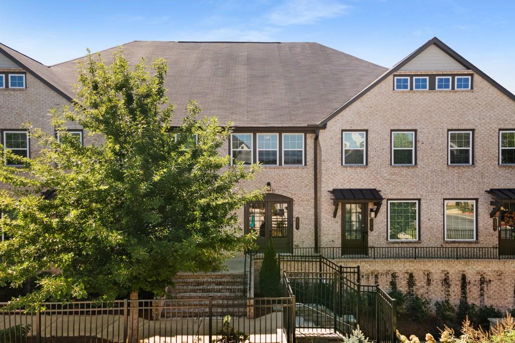 **Offered at $3,400/month furnished or $3,200/month unfurnished** Experience luxury living at the fully gated resort-style Reverie on Cumberland community. This 3-story townhouse, built in 2021, features hardwood floors, elegant crown moldings, and state-of-the-art appliances and upgrades. Enter through French doors into a bright, open-concept space with a chef's kitchen featuring modern white cabinetry, quartz countertops, a spacious island, gas cooktop, stainless steel appliances, and a walk-in pantry, all overlooking the dining and living areas. Enjoy a balcony perfect for relaxing and taking in the serene surroundings. The terrace level offers a spacious private office, ideal for remote work or business owners, that also serves as a bedroom with a Murphy bed and custom closet. The attached garage includes a Tesla charger for your convenience (can be removed if not needed). Upstairs, the tranquil primary suite serves as a retreat, featuring an oversized shower, double sink vanity, and a dream walk-in custom closet. A second bedroom, full bath, and laundry room complete the upper level. This gated community offers amenities such as a pool, cabana, gym, clubhouse, fire pit, and ample guest parking. Conveniently located just minutes from Publix, Costco, shopping, dining, I-285, and The Battery. Available for rent as soon as possible