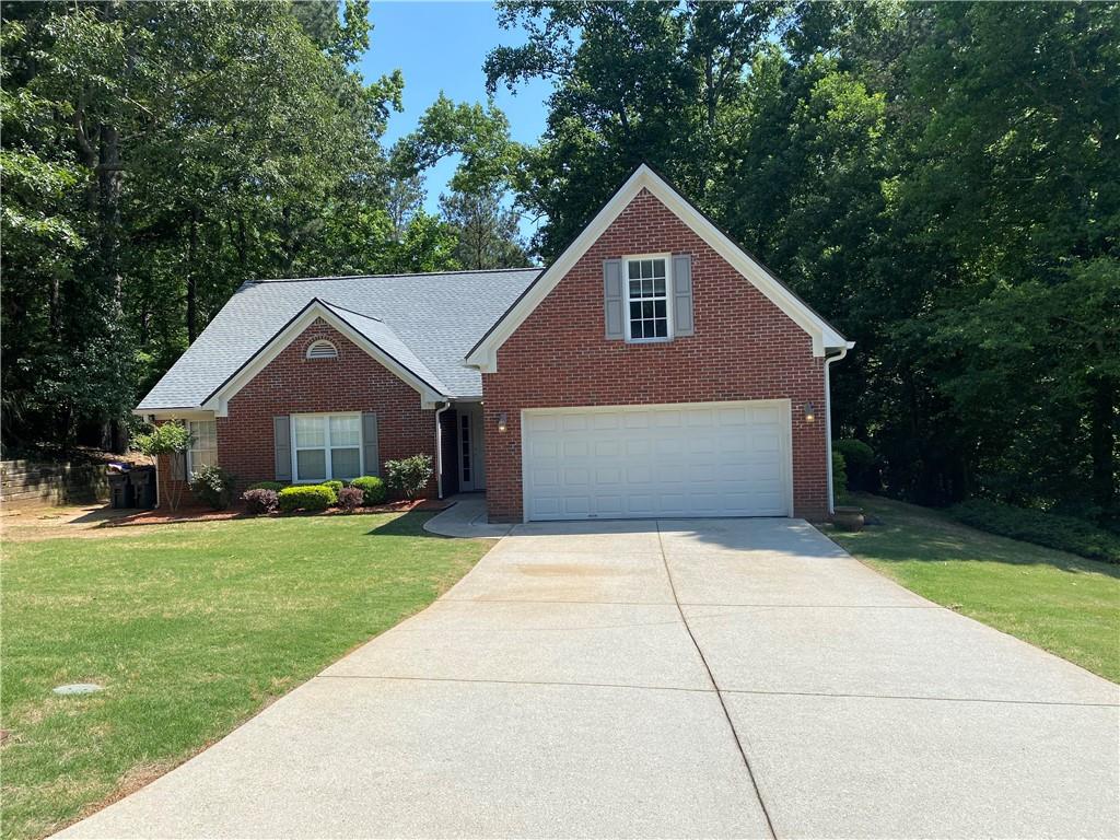 Rare find! Nestled in a quiet cul-de-sac, this charming brick-front ranch offers the perfect combination of comfort, style, and convenience. Located in the sought-after Collins Hill School District, this well-maintained home features 3 bedrooms plus a versatile bonus room—potential 4th bedroom and 2 full baths. The spacious owner’s suite includes a large walk-in closet and a private sitting area/office/nursery separated by elegant french doors. The renovated guest bathroom adds a modern touch, while the inviting family room with brick fireplace, creates a warm and welcoming atmosphere. A formal dining room and bright eat-in kitchen—complete with newer stainless steel appliances and ample cabinet space—offer plenty of room for entertaining. Step outside to a newer composite deck overlooking the large, fenced backyard—perfect for outdoor gatherings or peaceful evenings. The long driveway and attached garage provide abundant parking. Notable upgrades include newer roof with transferable warranty, fresh interior paint, and new flooring (2024). With no HOA, easy access to Gwinnett College, downtown Lawrenceville, shopping, dining, and major highways, this home combines modern updates with unbeatable location. Currently tenant-occupied—appointment required for limited showings.